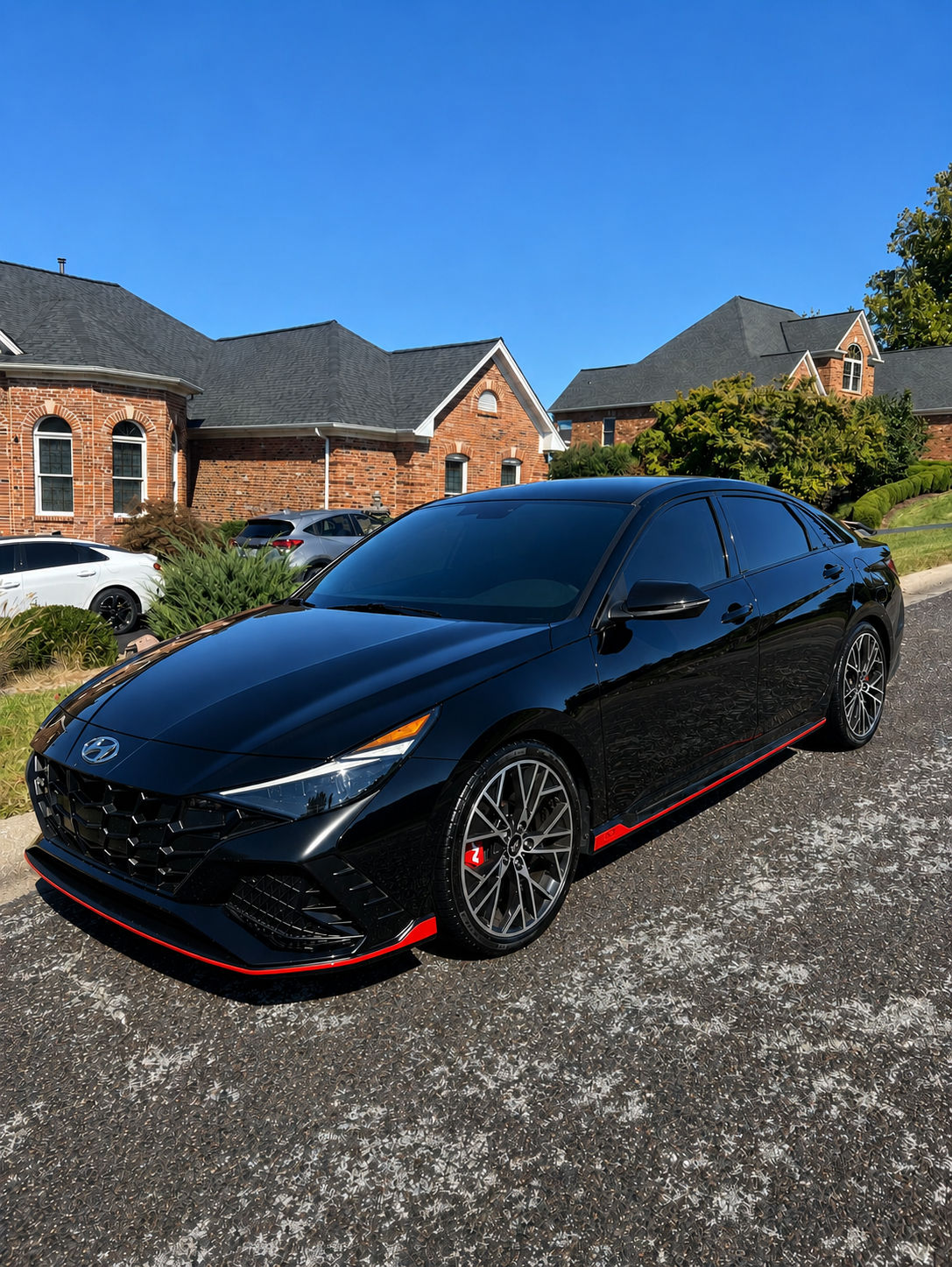 Glossy black sport sedan after a complete interior and exterior detail