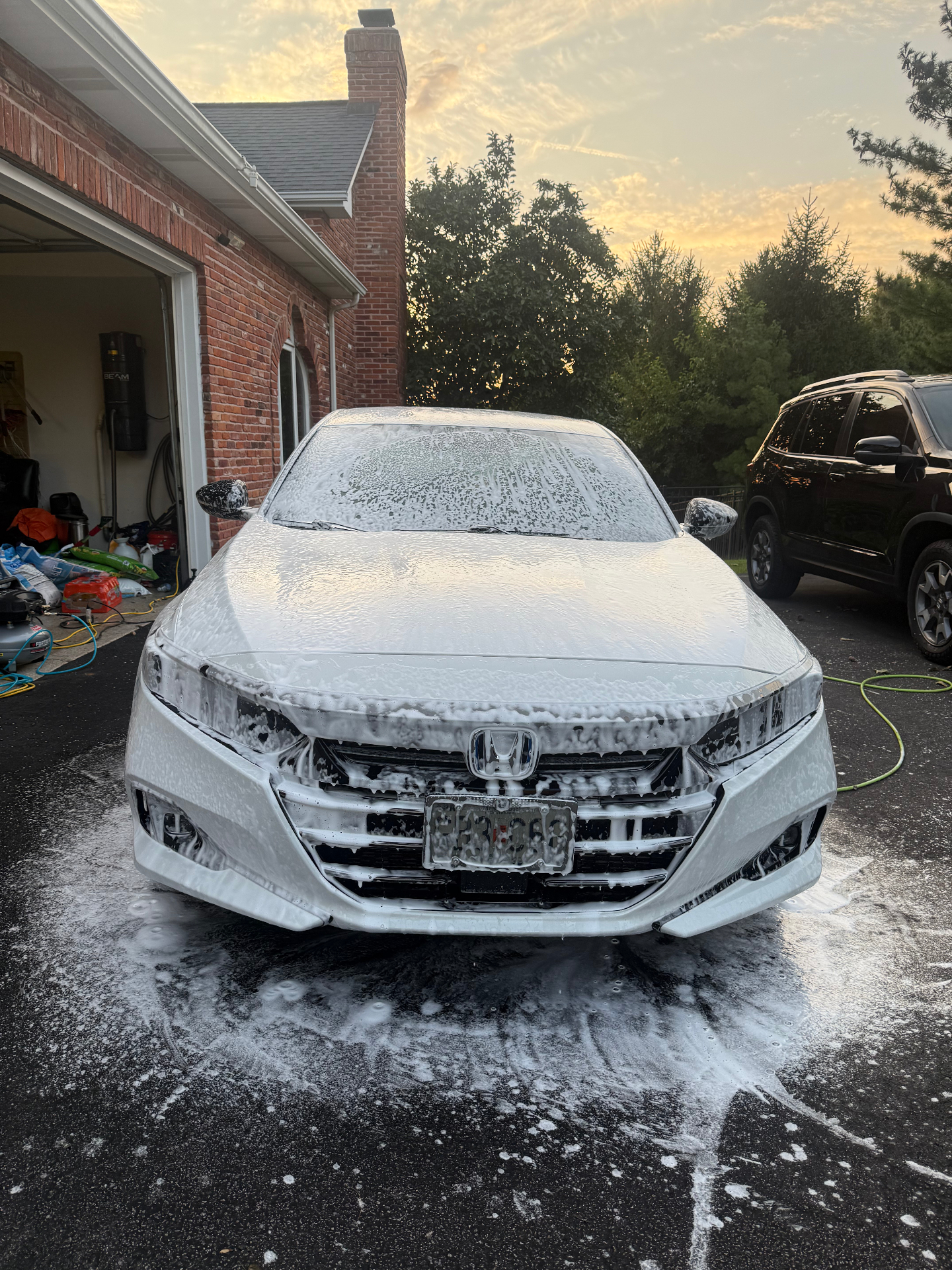 Honda Accord covered in thick foam during an exterior detail